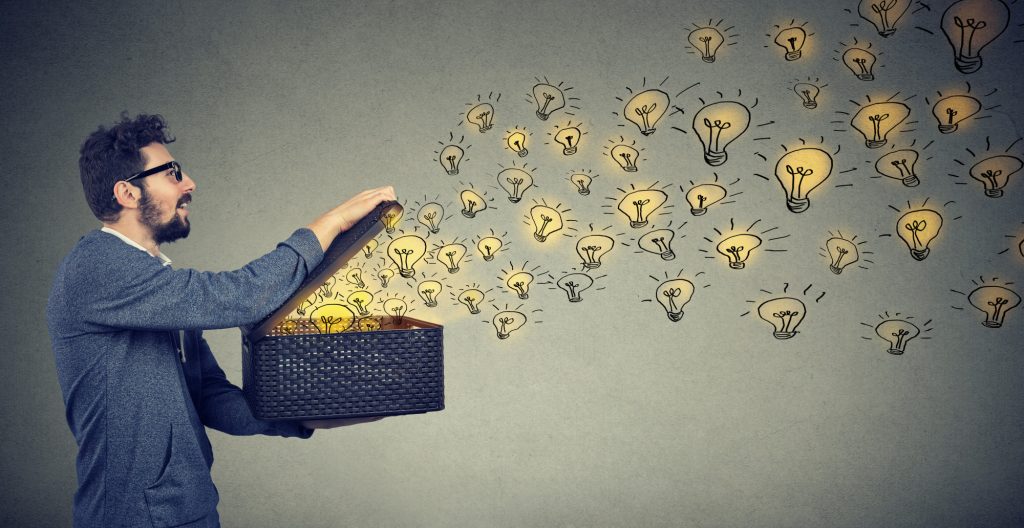 man opening box with lightbulbs symbolizing ideas