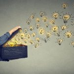 man opening box with lightbulbs symbolizing ideas