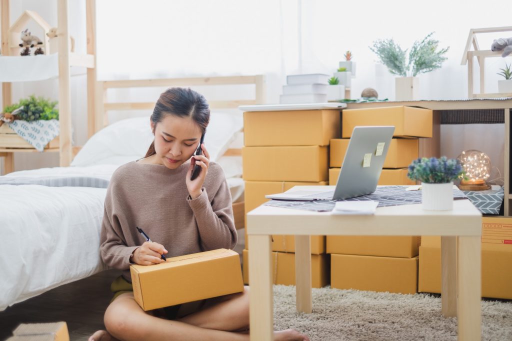 woman shipping boxes from home