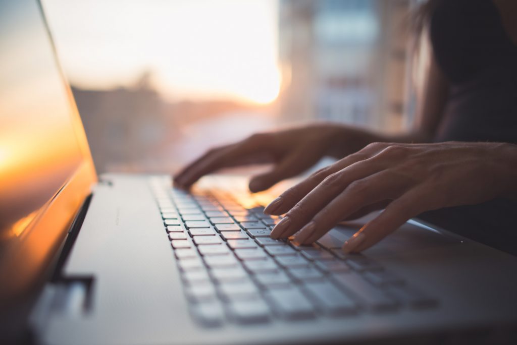 person typing on computer