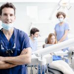 Dentist and His Assistants with a Patient