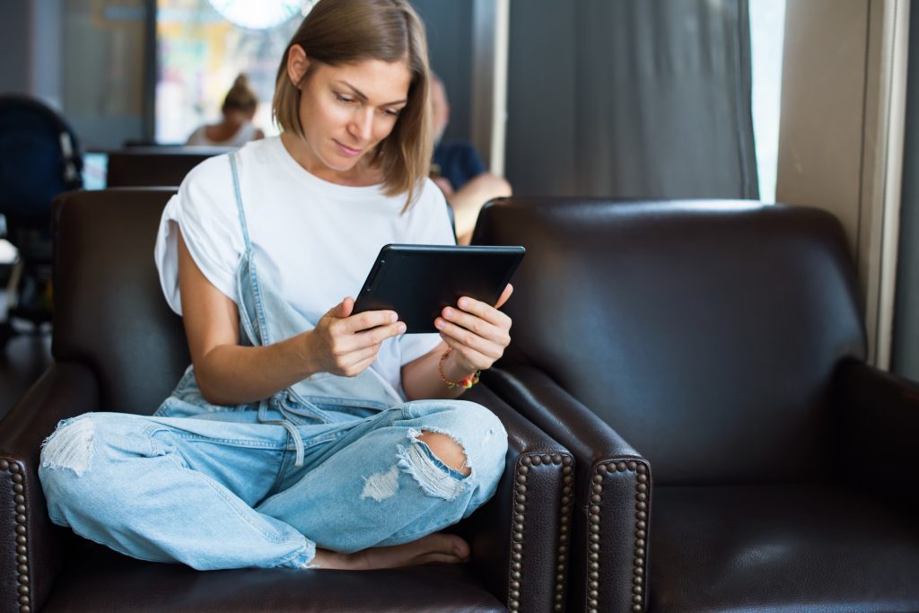 Person Watching an Explainer Video on a Tablet