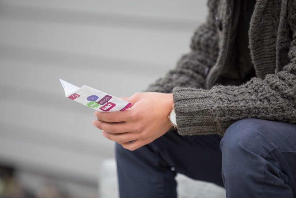 Person Reading a Flyer